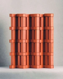 An arrangement of structured rectangular orange blocks forming a repeating architectural pattern against a grey background.