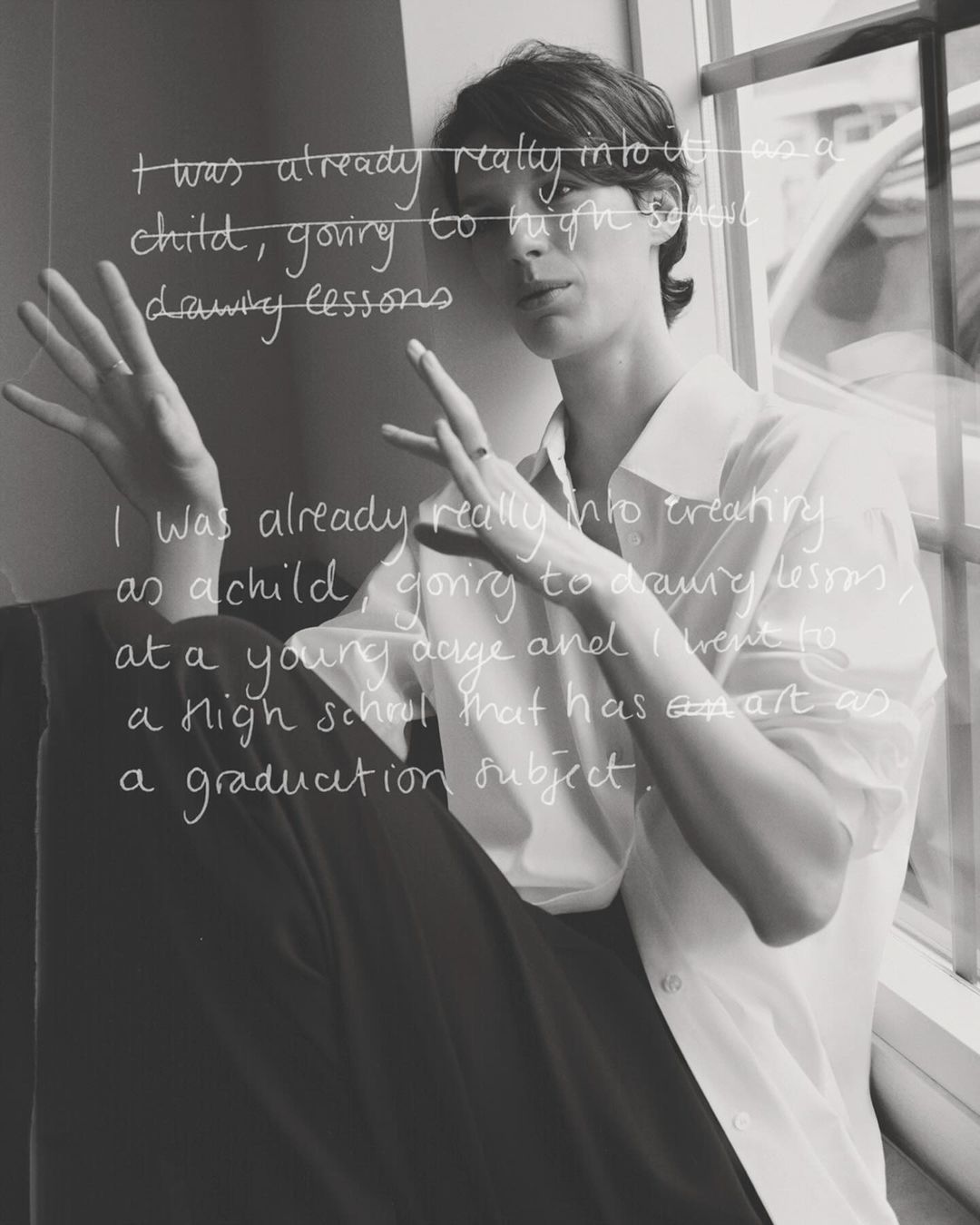 Monochrome portrait of an adult woman with short brown hair, casually posed in a white shirt near a window with superimposed text.