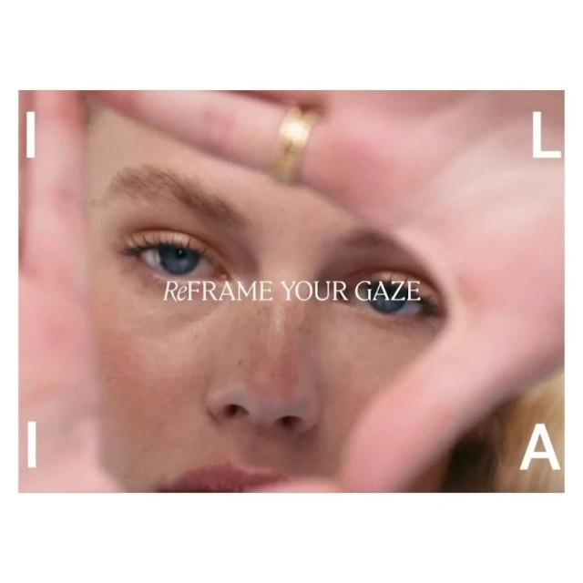 Close-up beauty shot of a fair-skinned adult female model with her hands framing her face, showcasing the cosmetics product. Studio lit.