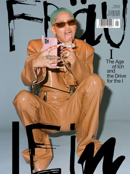 Magazine cover featuring a person with mint green hair, sunglasses, and a tan outfit, holding a pink cell phone, with bold typography.