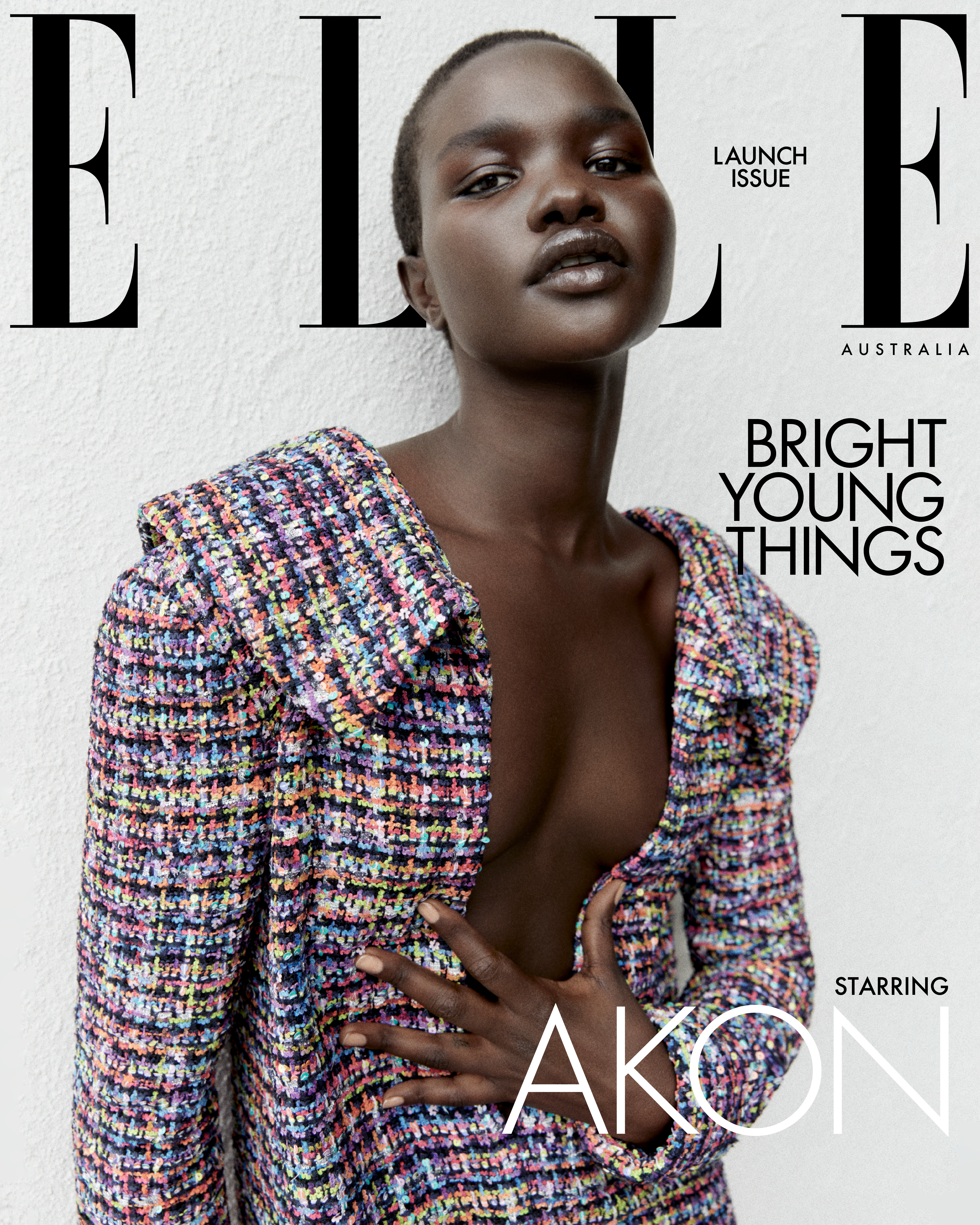Elle Australia cover featuring a Black woman with short hair wearing a multicoloured tweed jacket against a textured white wall.