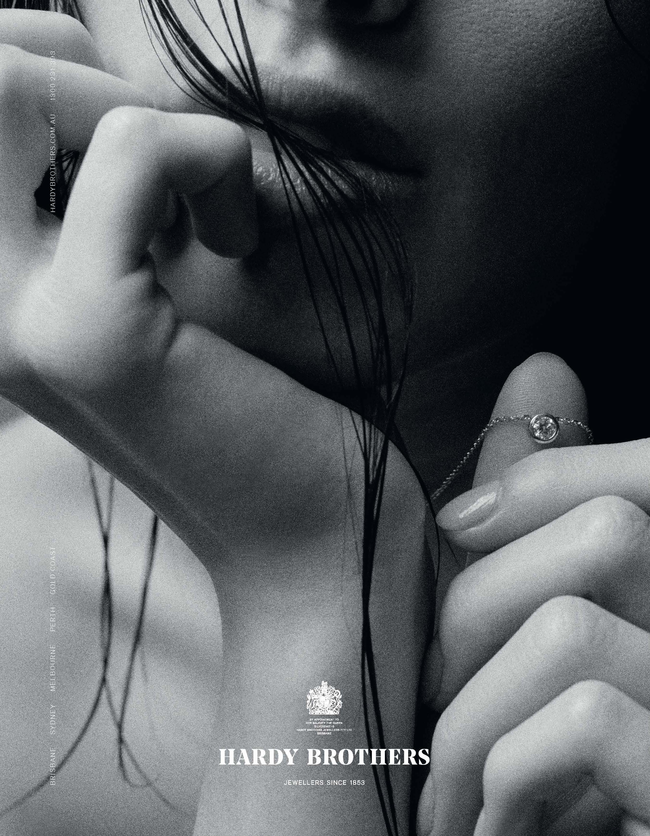 Close-up fashion shot of a woman's face and hands with a ring on a chain. Emphasizes jewelry and natural lighting in a studio setting.