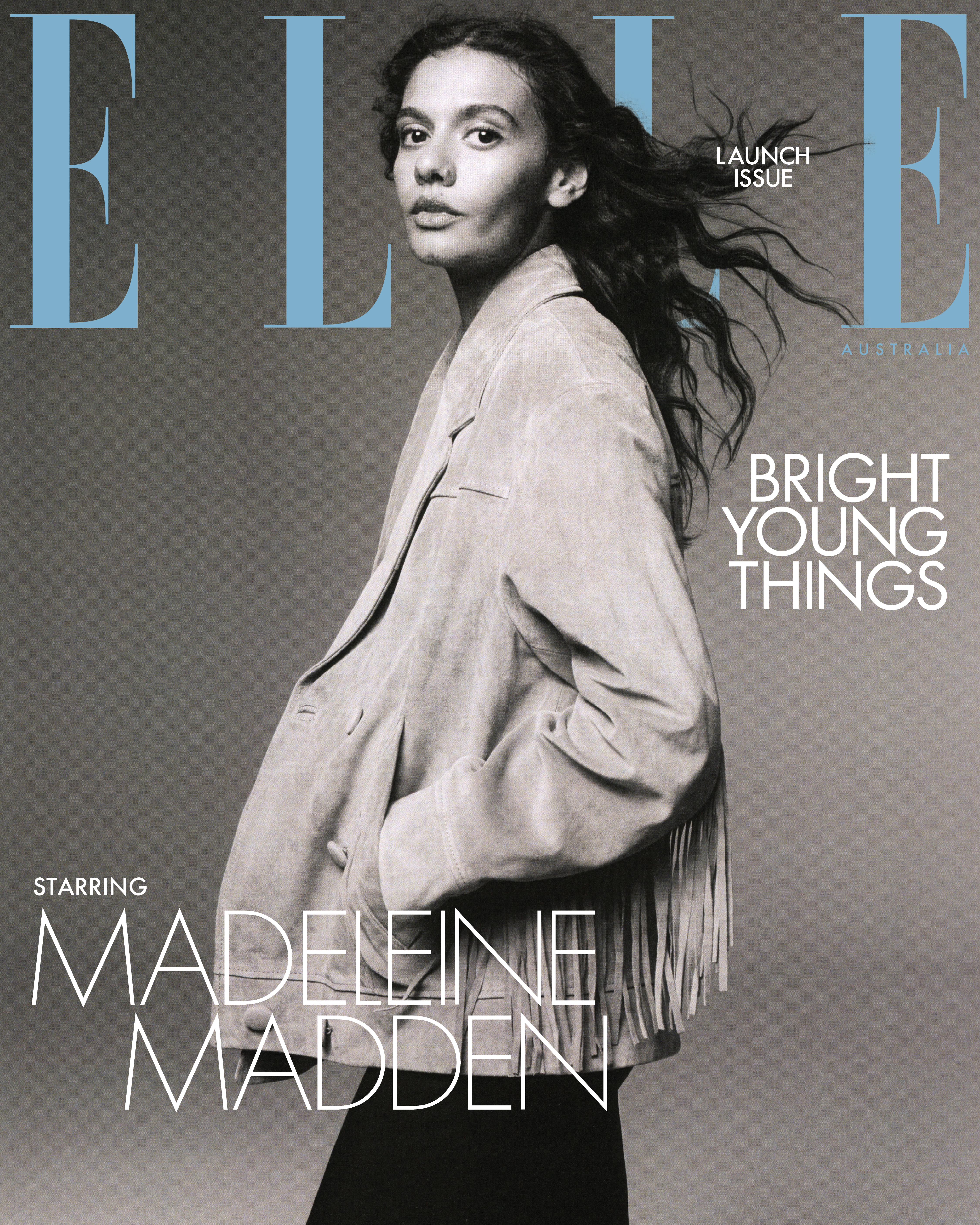 Elle Australia magazine cover featuring model Madeleine Madden in a fringe jacket against a grey backdrop with blue magazine logo.