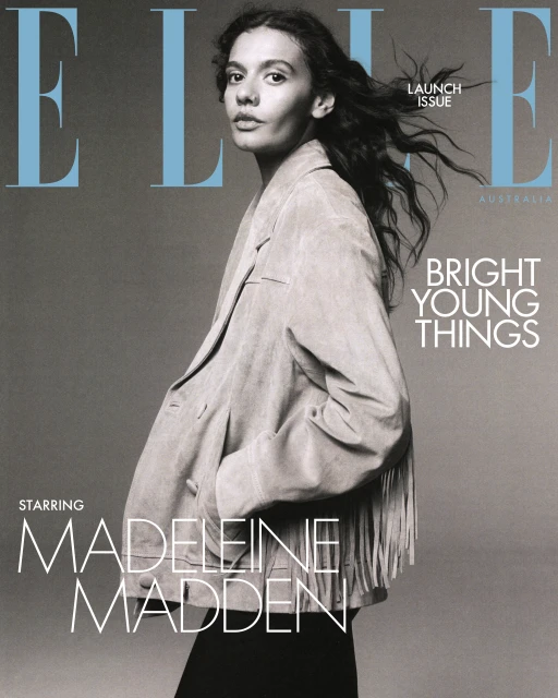 Elle Australia magazine cover featuring model Madeleine Madden in a fringe jacket against a grey backdrop with blue magazine logo.