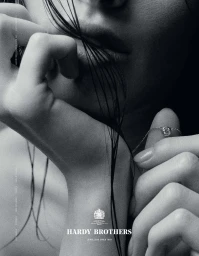 Close-up monochrome portrait of a woman with wet hair wearing a diamond pendant necklace by Eminente Creative Production