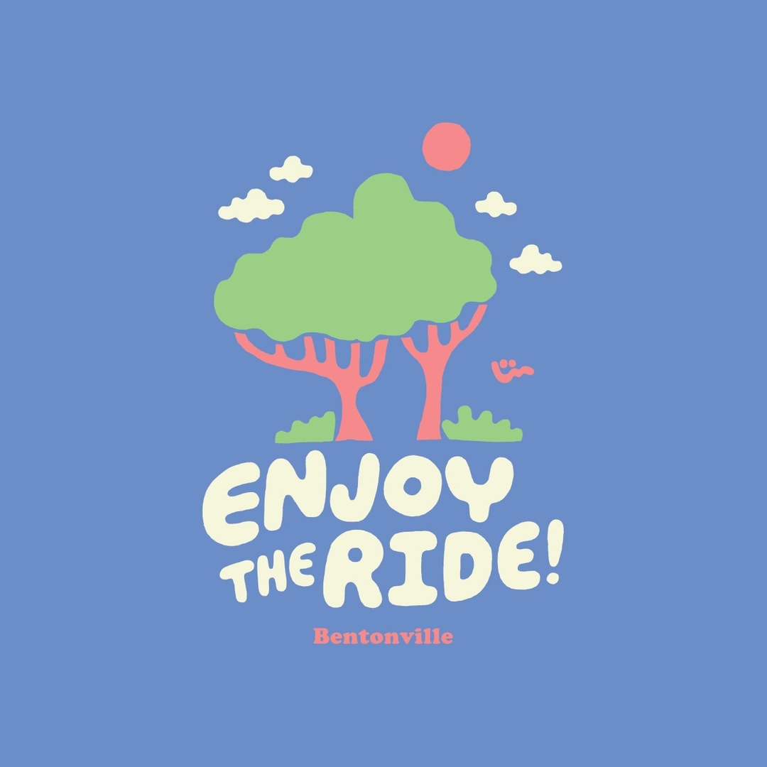 Whimsical illustration featuring cartoon trees, clouds, and sun, along with stylized text "Enjoy the Ride!" and the location "Bentonville."