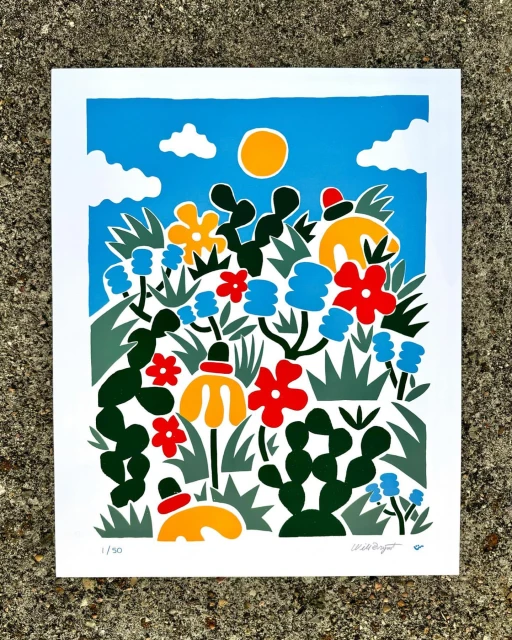 Colourful art print featuring a vibrant garden scene with stylized flowers, cacti, and a sun against a blue sky with white clouds.