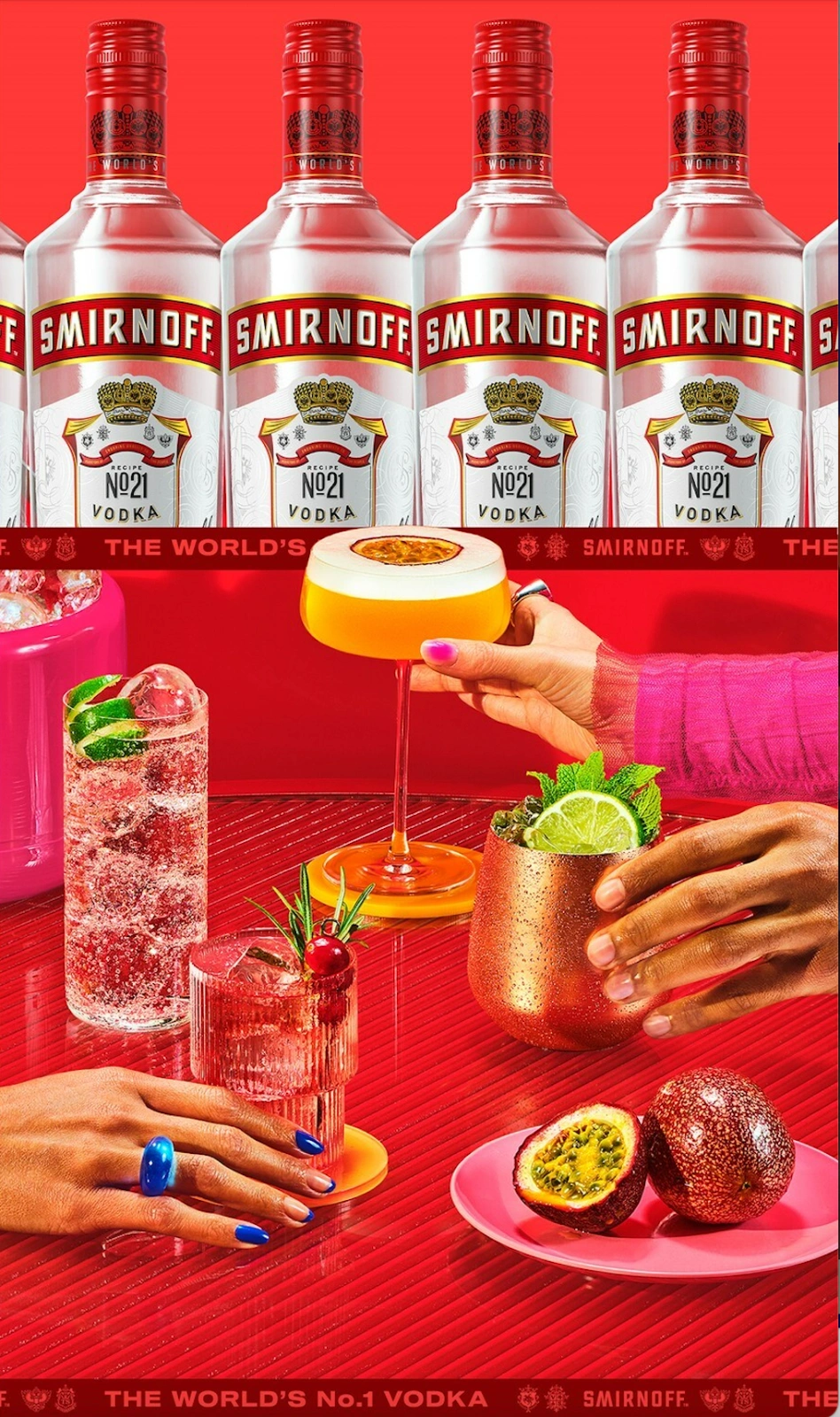 Smirnoff vodka bottles lined up above colorful cocktails on a red textured surface with hands reaching for the drinks.