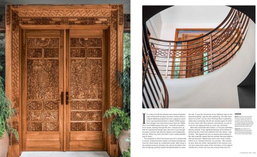 Ornate wooden double doors with carved patterns, framed by greenery, showcase craftsmanship and architectural detail.
