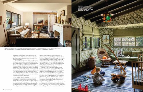 Cozy interior showcases eclectic design with sofas, fireplace, toys, and a kid playing near a construction crane toy, creating a warm, lived-in atmosphere.