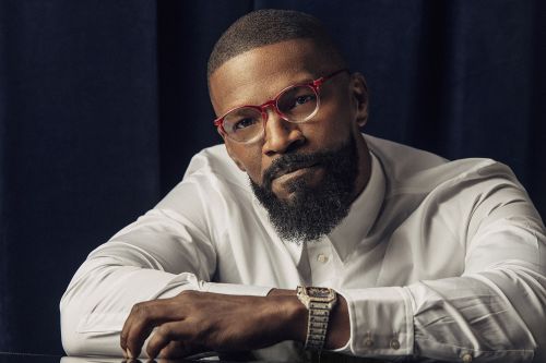 Portrait of Jamie Foxx wearing red-rimmed glasses and a white dress shirt, photographed by Nicholas Maggio.