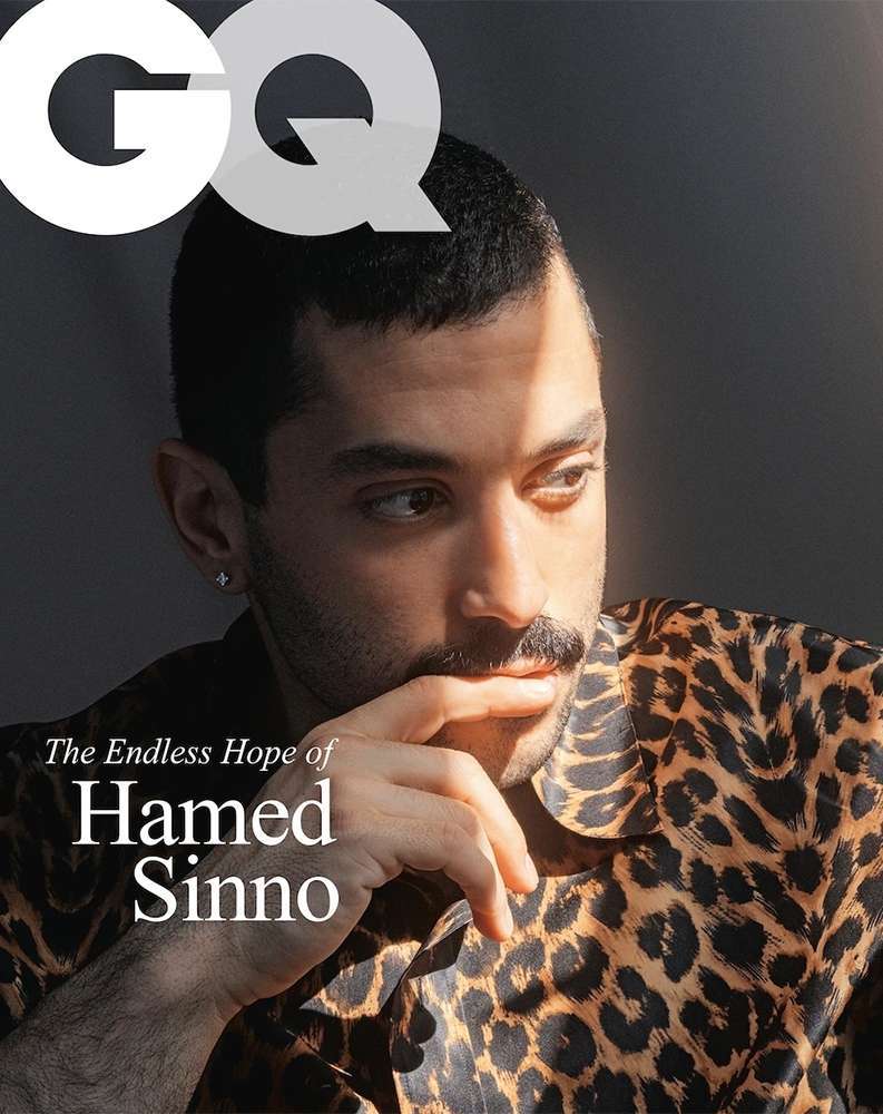 Magazine cover featuring a stylish man with a mustache in a leopard print shirt, gazing off-camera, with the GQ logo prominently displayed.