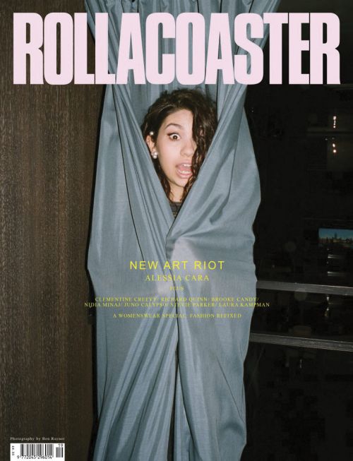 Alessia Cara on the cover of Rollacoaster magazine peeking out from behind a blue curtain with bold pink text on top.