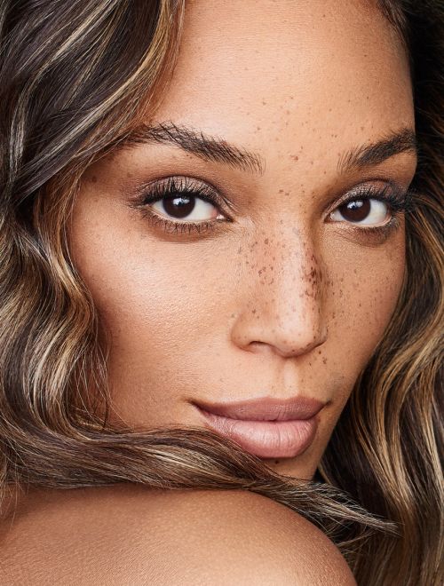 Close-up portrait of a woman with freckles and highlighted hair by make-up artist Sophie Ono