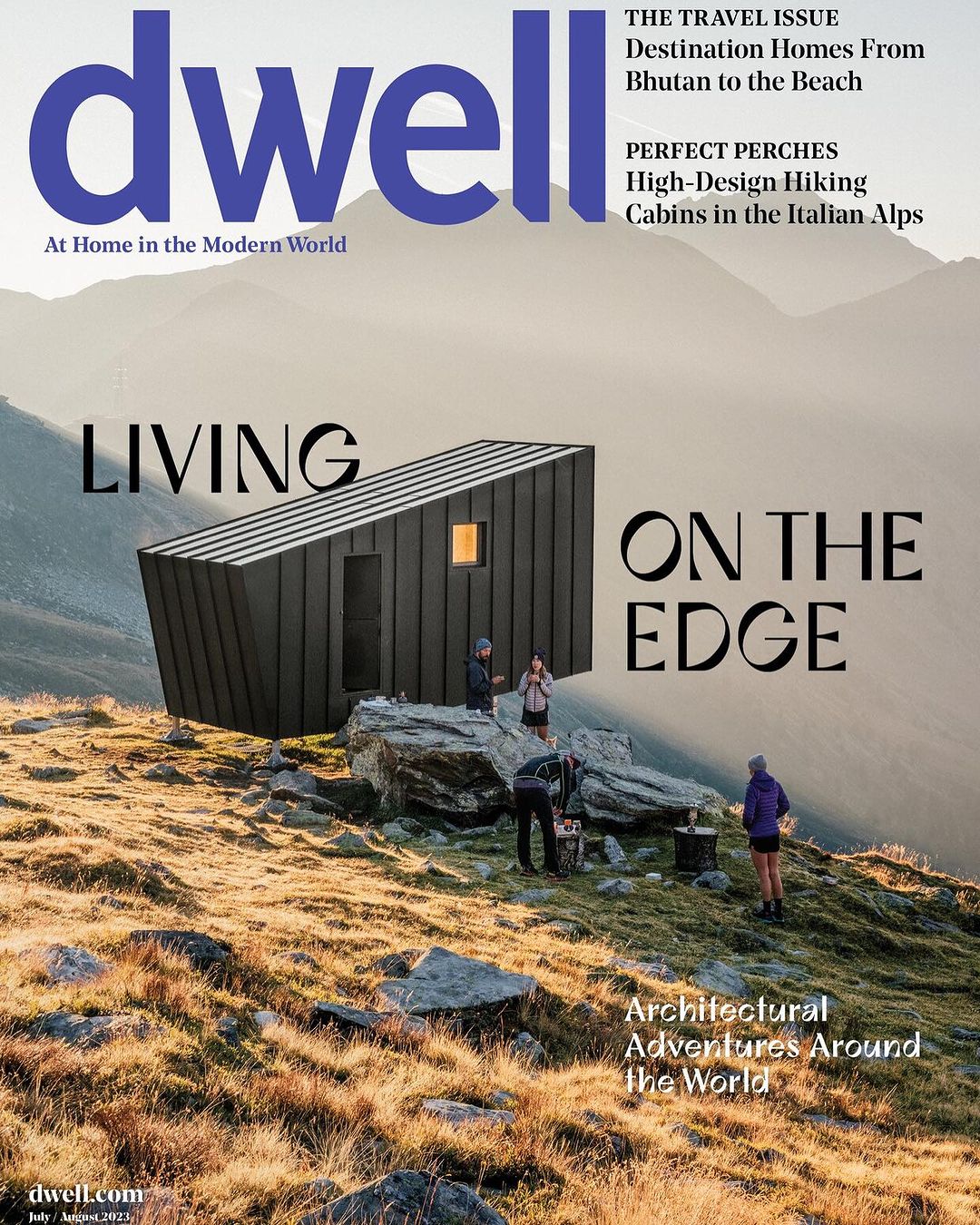 Dwell magazine cover featuring modern cabin architecture, mountains, and a group of people in a travel and lifestyle context.