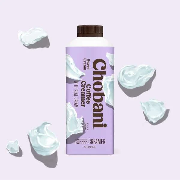 Chobani coffee creamer bottle in sweet cream flavor, surrounded by swirls of cream on a soft lavender background, product shot.