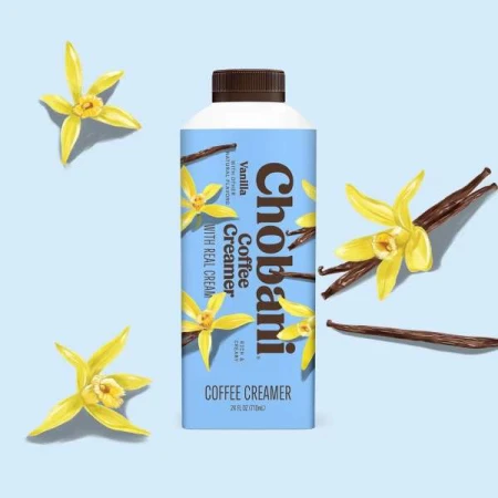 Chobani Vanilla Coffee Creamer in a blue and white carton with vanilla flowers and vanilla beans against a light blue backdrop.