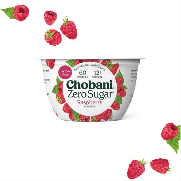 Chobani Zero Sugar raspberry yogurt cup on a white background with fresh raspberries scattered around the product container.