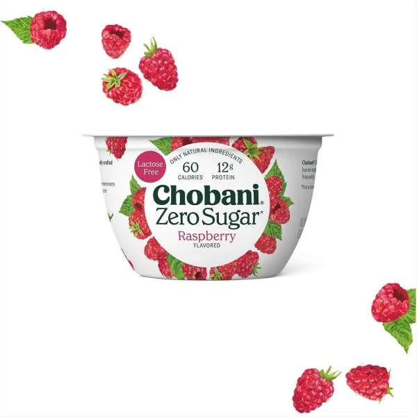 Chobani Zero Sugar raspberry yogurt cup on a white background with fresh raspberries scattered around the product container.