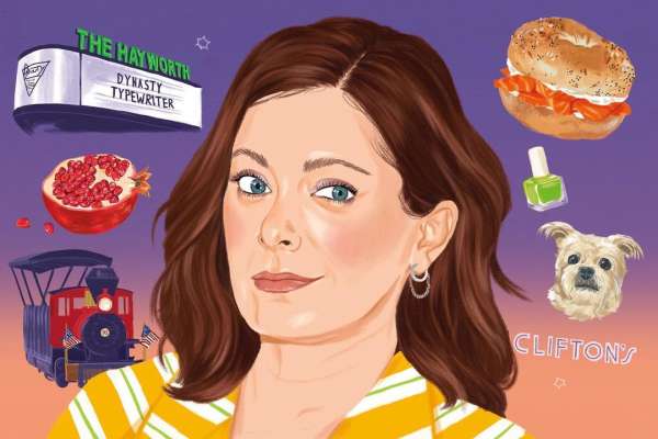 Illustration of a woman with brown hair and blue eyes, against a purple background with a bagel, pomegranate, and miniature train.