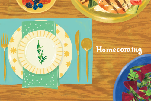 Overhead shot of a table setting with plates, cutlery, dishes of berries and vegetables, and the word 'Homecoming' on the wood surface.