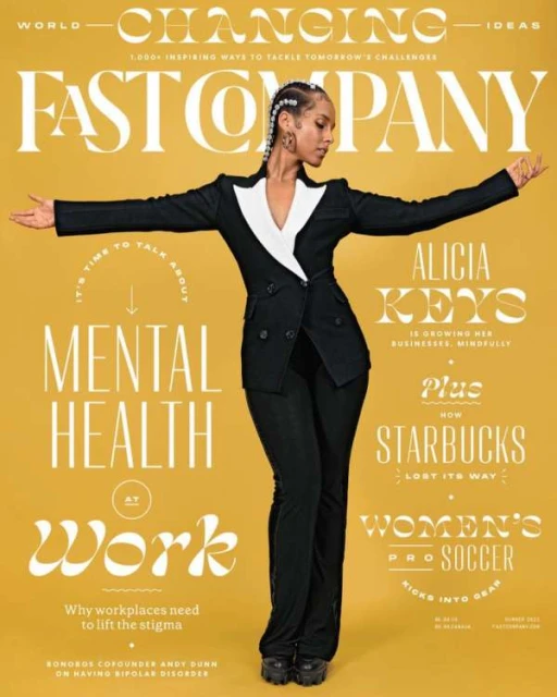 Alicia Keys on a Fast Company magazine cover in a black suit, standing with arms outstretched against a yellow background with white text.
