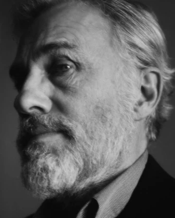 Black and white portrait of an older man with a full beard and textured hair, shot by Erik Tanner.