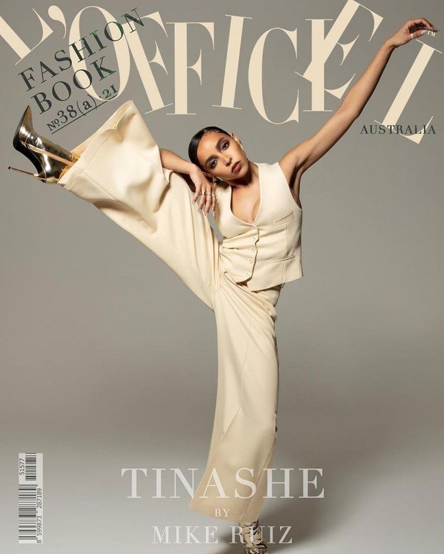 Fashion magazine cover featuring Tinashe striking a pose in cream-colored outfit and gold heels against a neutral backdrop with magazine text.