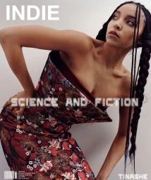 Tinashe wearing a structured floral bustier dress with long braided hair against a plain background
