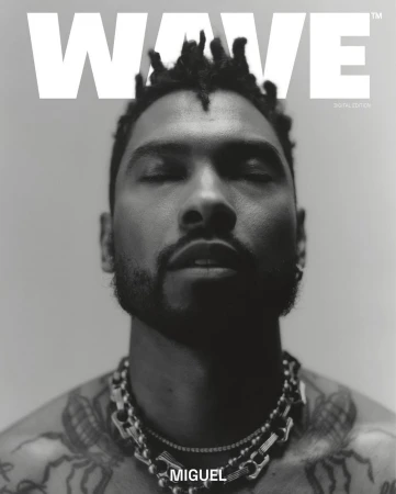 Black and white portrait of Miguel for Wave magazine, showcasing his dreadlocks, jewelry, and tattoos in a close-up studio shot.