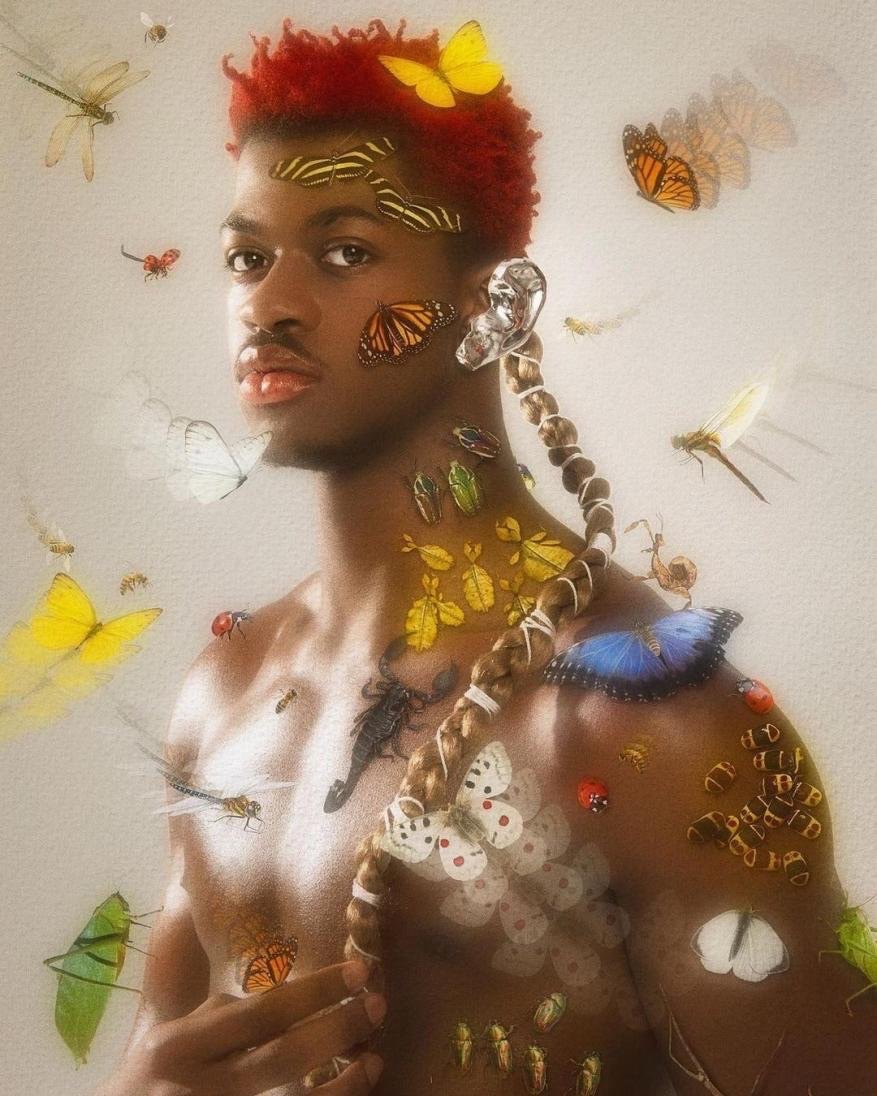 Man with reddish hair posing with various insects and butterflies covering his face and body in a surreal, ethereal composition.