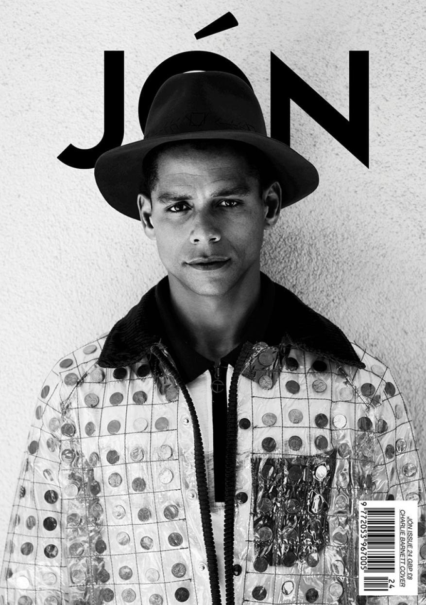 Black and white portrait of a man wearing a hat and patterned jacket, against a neutral wall with 'JÓN' magazine typography.