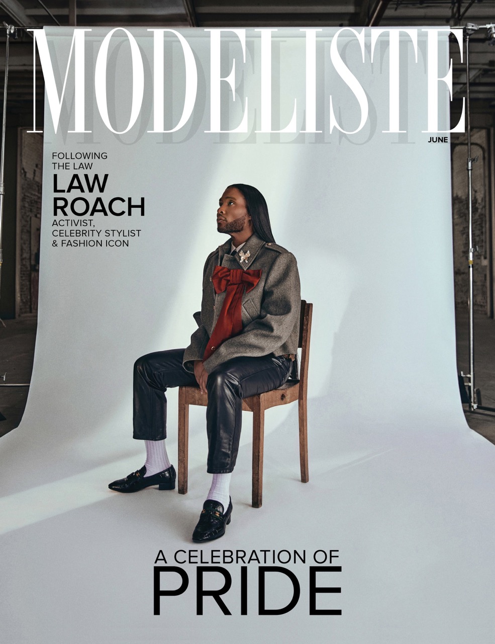 Magazine cover featuring Law Roach, activist and celebrity stylist, seated on a chair in a photo studio setting with industrial background.