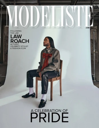 Magazine cover featuring Law Roach, activist and celebrity stylist, seated on a chair in a photo studio setting with industrial background.