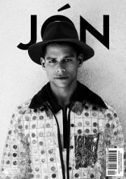 Portrait of a man in a wide-brimmed hat and clear patterned jacket with make-up by Amber Amos in Los Angeles