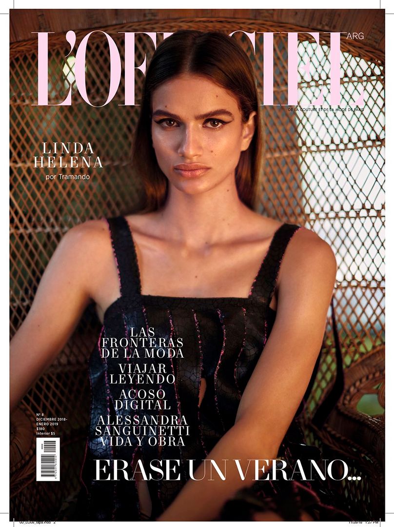 Magazine cover featuring model Linda Helena wearing a black tank top, posing indoors with a wicker chair background, and the "L'Officiel" logo.