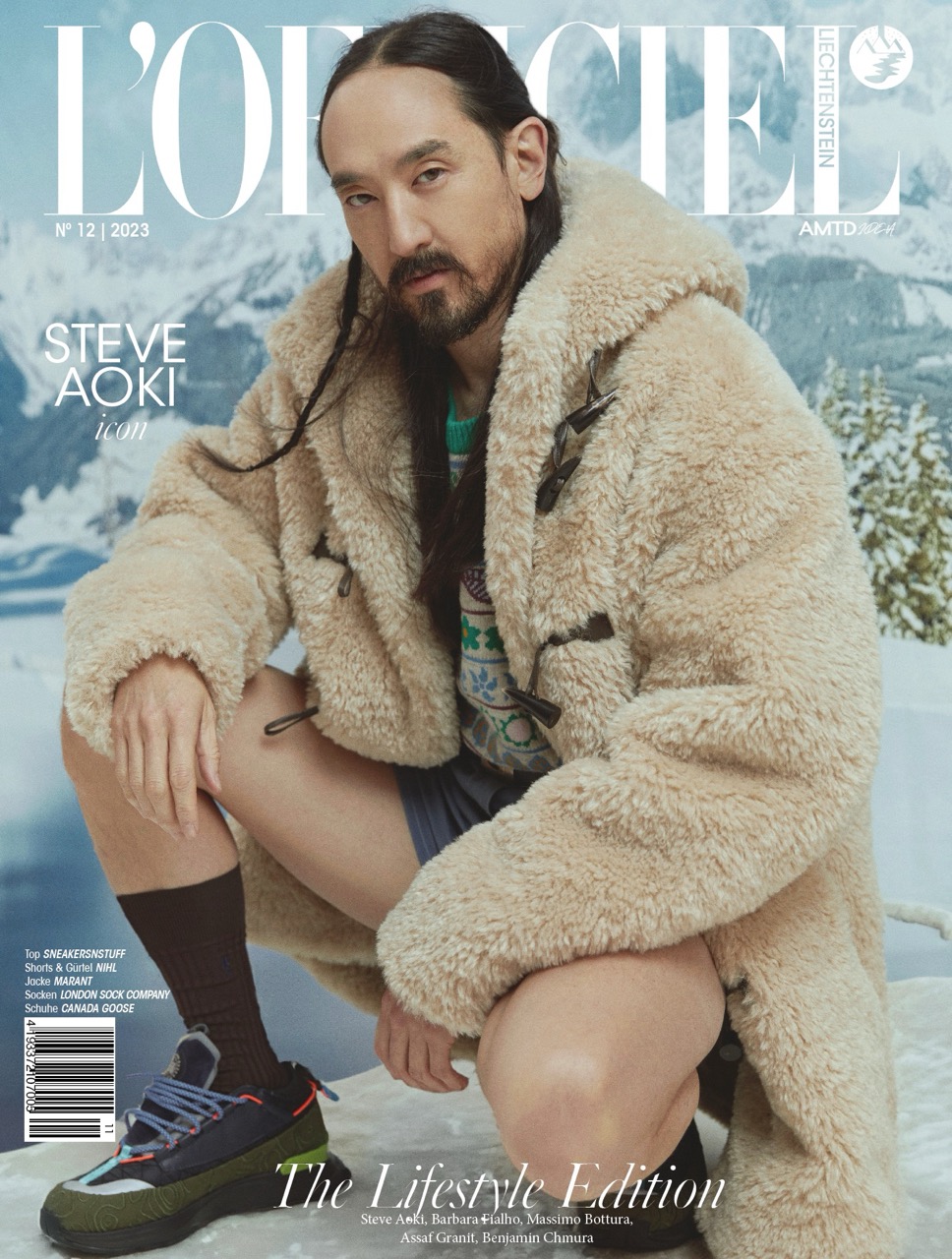 Magazine cover featuring Steve Aoki wearing a fur coat and shorts, with a snowy mountain backdrop for L'Officiel Liechtenstein's Lifestyle Edition.