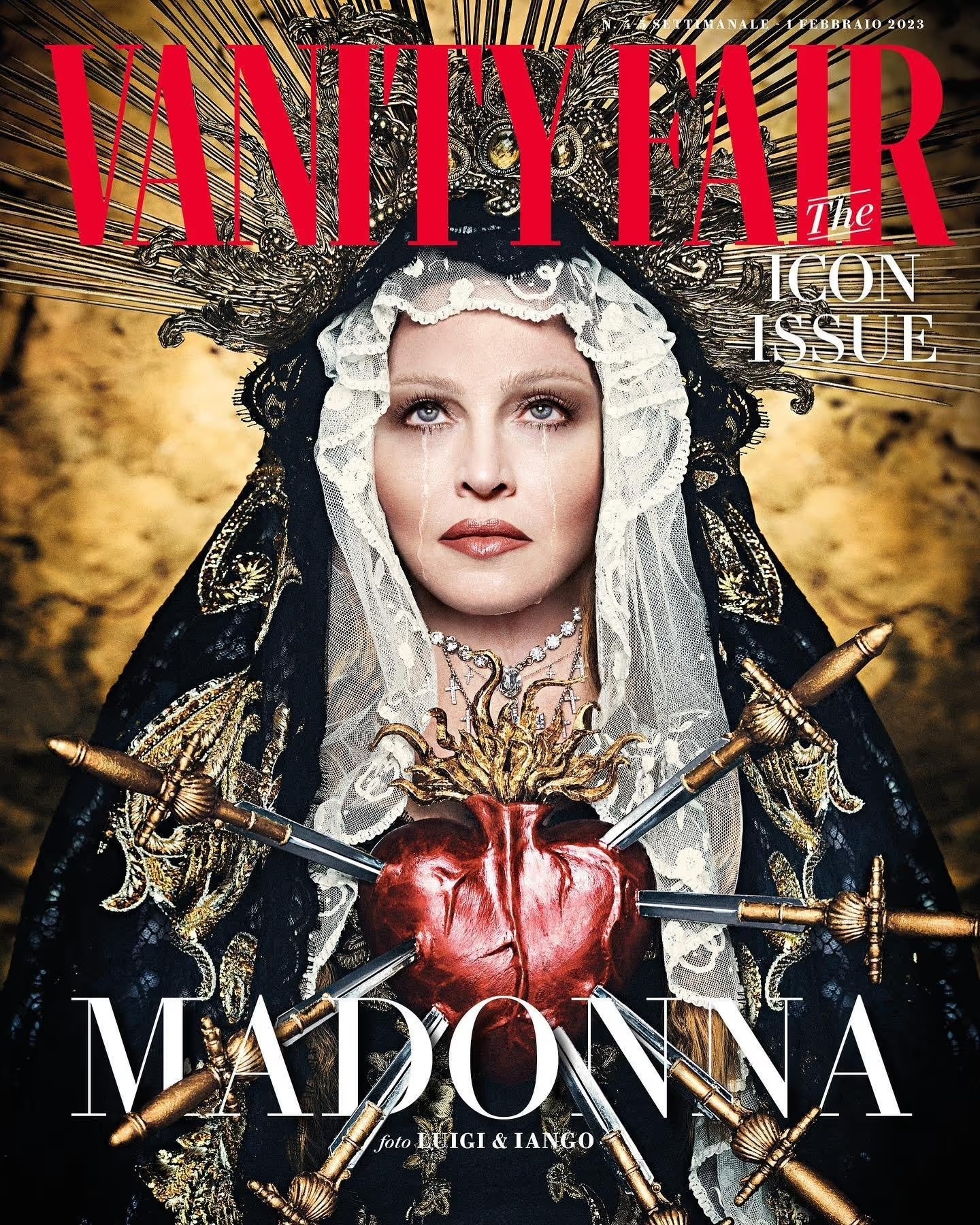 Madonna on Vanity Fair cover: portrait of the singer wearing a jeweled headdress and black veil, adorned with swords and a heart.