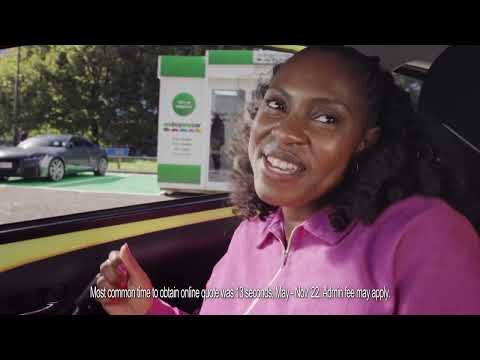 A medium shot shows a smiling African-American woman inside a car with a grey car and an insurance kiosk visible through the window.