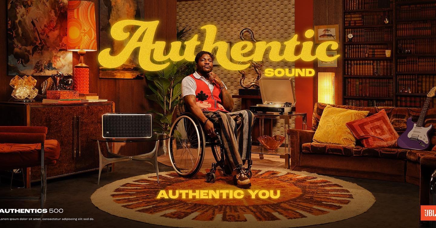 Man in wheelchair in retro living room setting next to JBL Authentics 500 speaker, vintage furniture, and 'Authentic Sound' text overlay.
