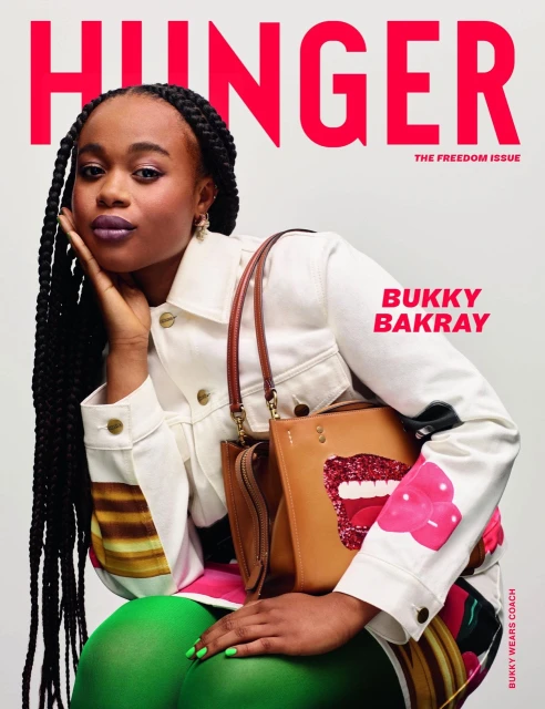 Hunger Magazine cover featuring Bukky Bakray. She is wearing a cream jacket with green leggings and carrying a Coach purse.