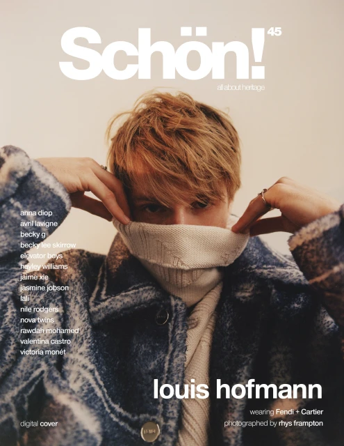 Schön! Magazine cover featuring Louis Hofmann in a blue jacket and cream sweater, posing with a partially covered face.