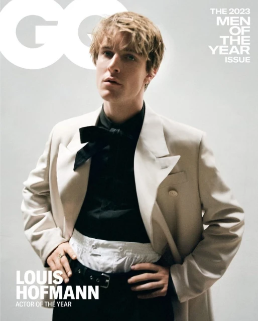 Magazine cover featuring Louis Hofmann, the 'Actor of the Year,' wearing a black shirt, bowtie, off-white suit, and black pants against a neutral backdrop.