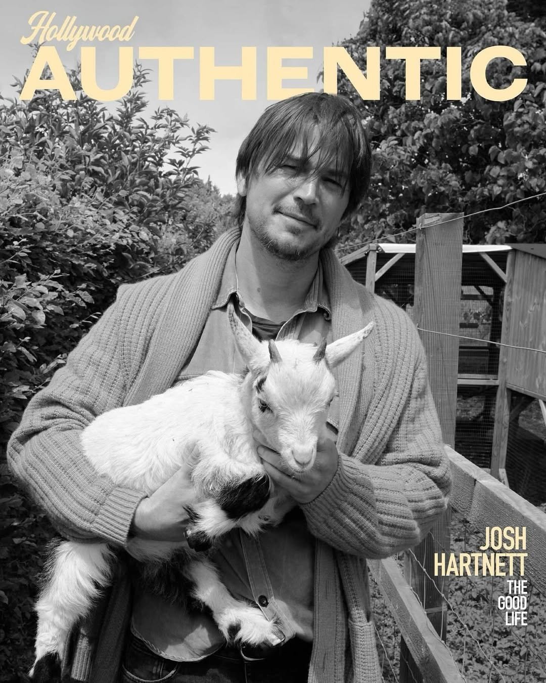 Black and white portrait of Josh Hartnett holding a small white goat, with the words 'Hollywood Authentic' visible at the top.