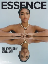 Lori Harvey wearing a statement gold snake necklace in an editorial magazine cover portrait with reflection