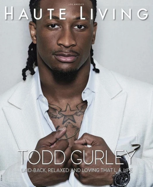 Todd Gurley on Haute Living cover: an African-American man in a white suit, gold chain, and watch. Fashion and lifestyle portrait.