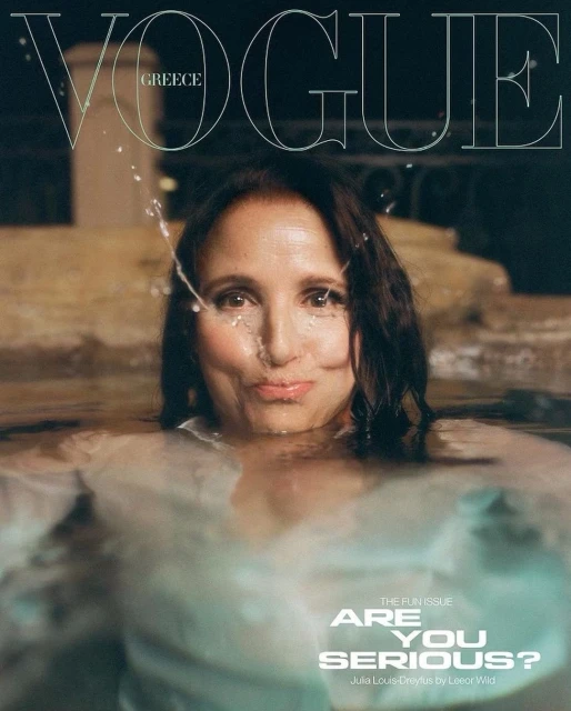Vogue Greece cover featuring Julia Louis-Dreyfus partially submerged in water, looking at the camera with water splashing her face.
