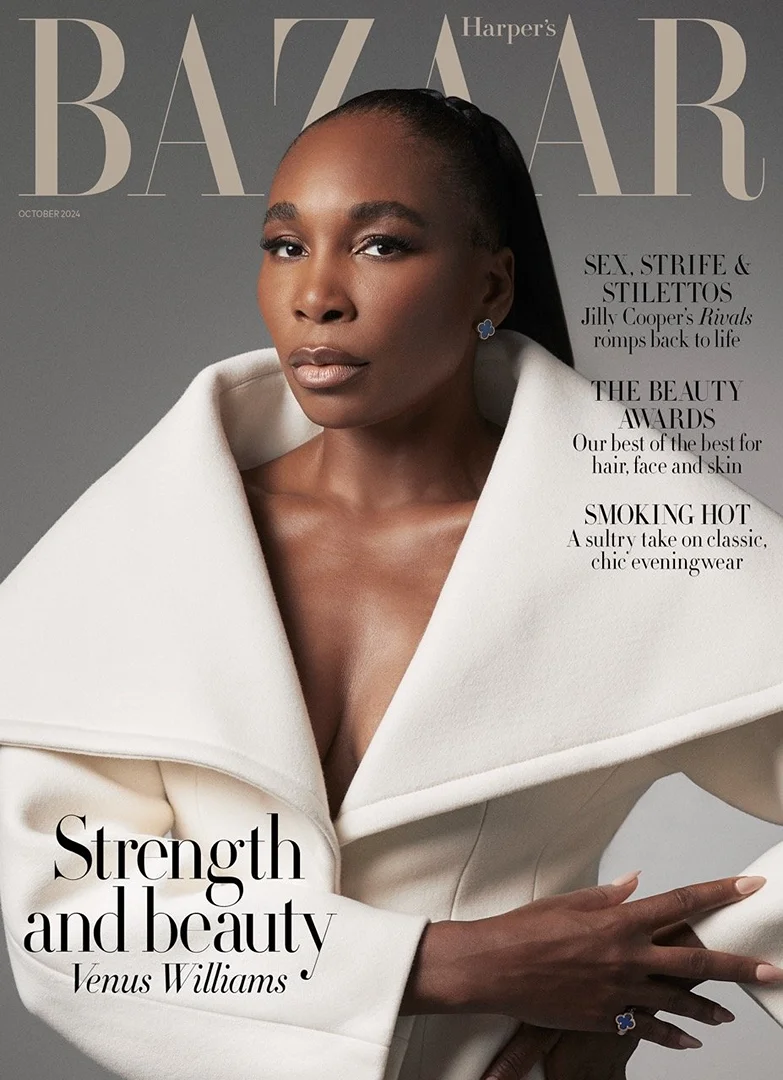 Venus Williams gazes in a sophisticated magazine cover shot; she wears a cream-colored coat with jewelry and a neutral makeup palette.