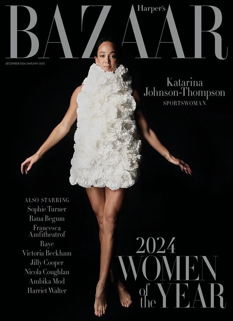 Katarina Johnson-Thompson, sportswoman, poses on Harper's Bazaar cover in a white, ruffled dress against a dark backdrop with names listed.