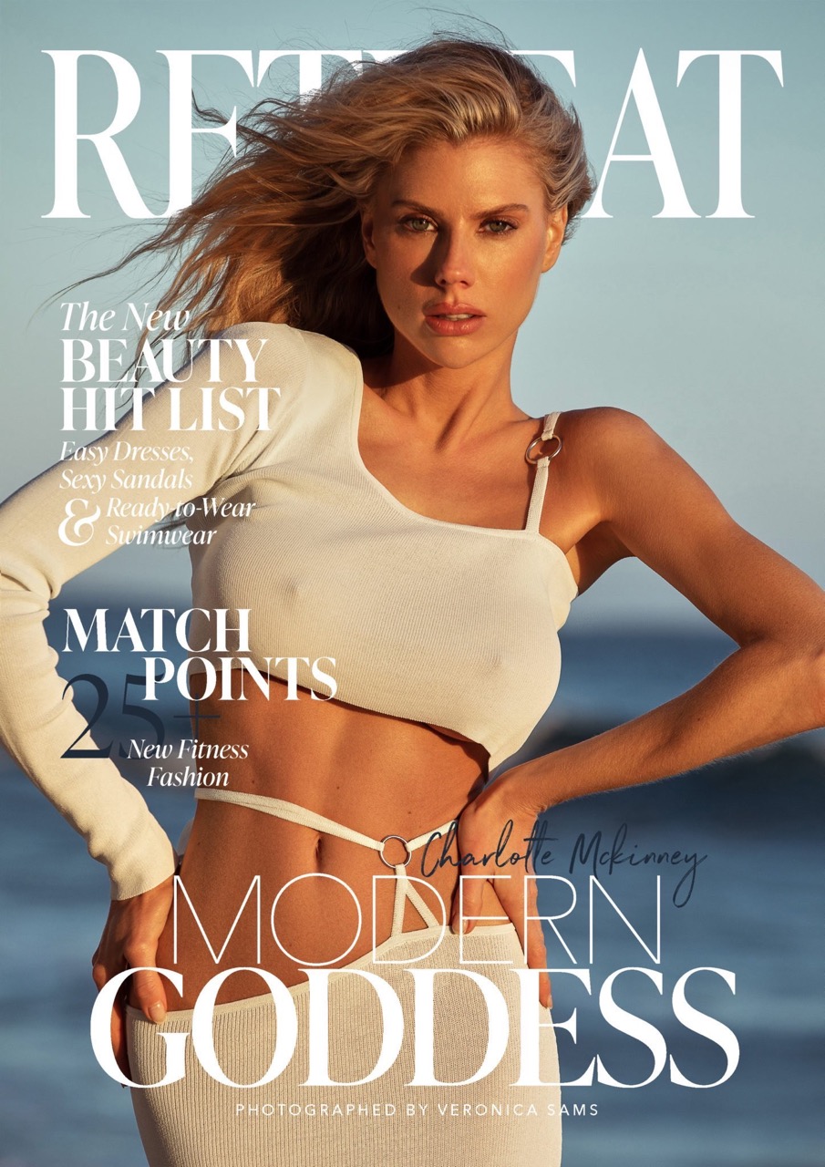 Magazine cover featuring a woman with blonde hair wearing a white outfit, posing in front of a blurred background with ocean views.